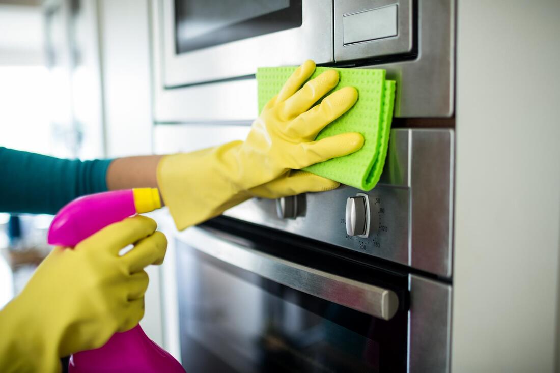 Appliance cleaning the stove or oven.